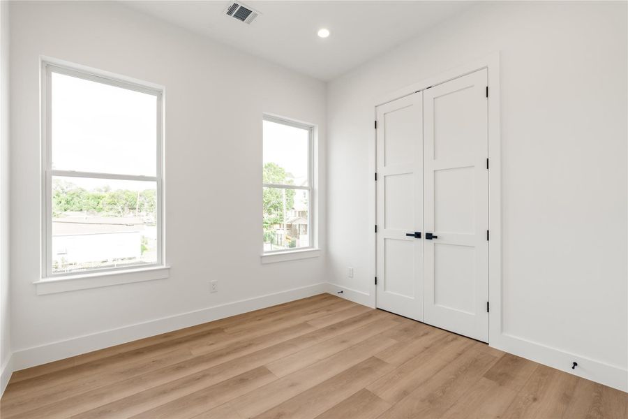 Bright and well-proportioned, this room offers the flexibility to become whatever it needs to be — a guest room, an office, a kid's room that can grow with them. Big windows keep it feeling open no matter how it's used.