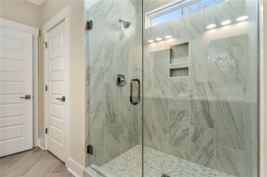 This modern bathroom features a spacious shower wi