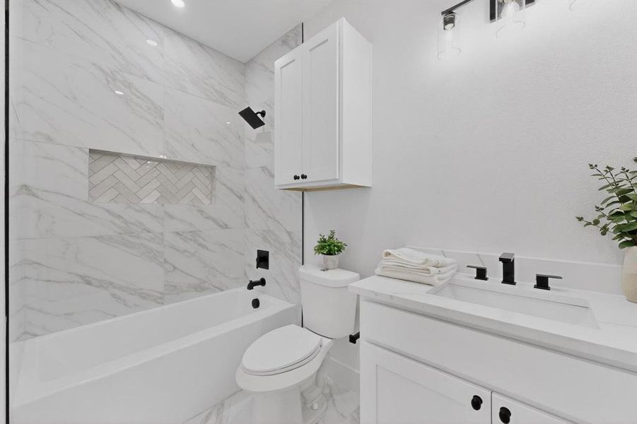 Full bathroom featuring vanity, shower / tub combination, and light marble finish flooring