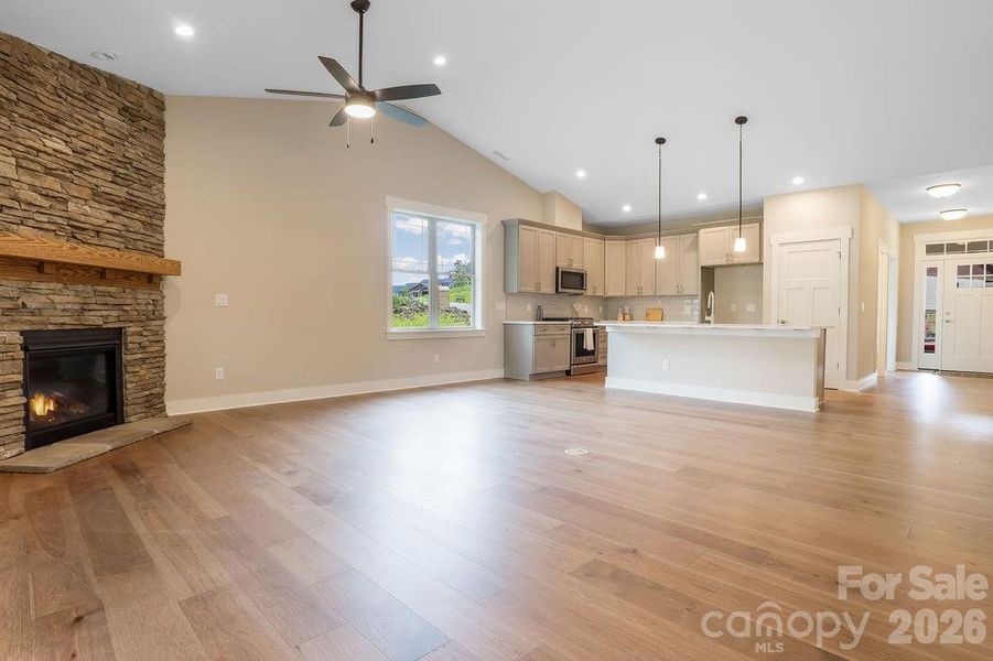Large open concept with vaulted ceilings and ceiling fan