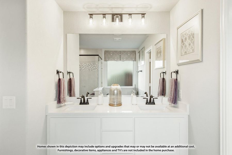 Bathroom with double sink vanity, white cabinets, large mirror, and four-bulb light fixture above Bathroom with double sink vanity, white cabinets, large mirror, and four-bulb light fixture above