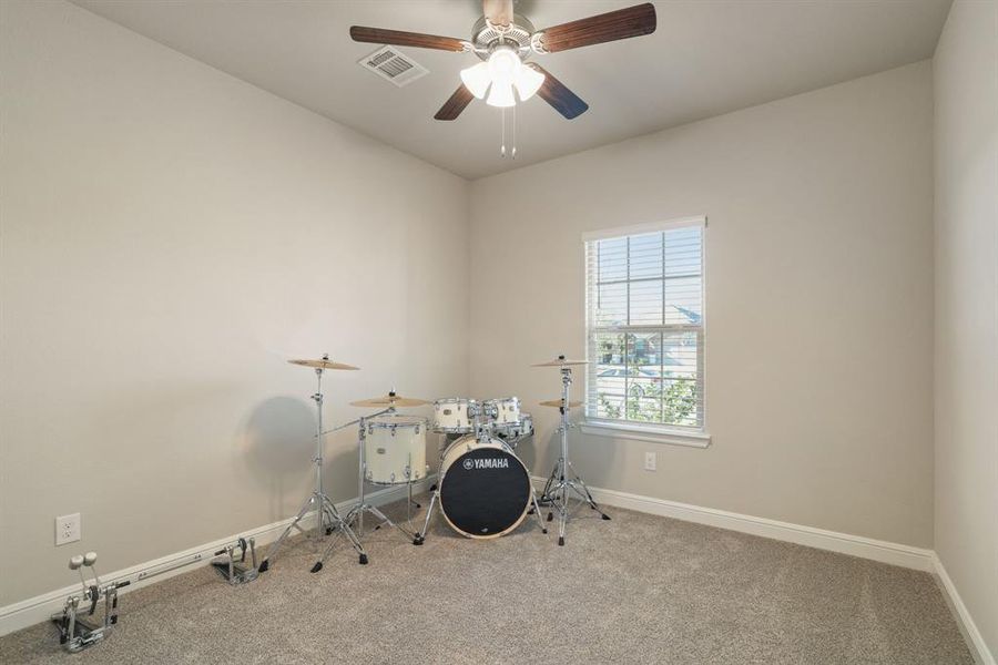 Misc room featuring carpet floors and ceiling fan Misc room featuring carpet floors and ceiling fan