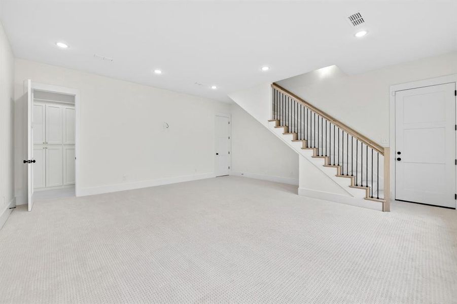 Large media room or flex room located downstairs off the kitchen area.  Note the door in back is a FULL pool bath with shower and plenty of cabinets for storage