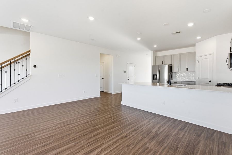 A kitchen with white cabinets.