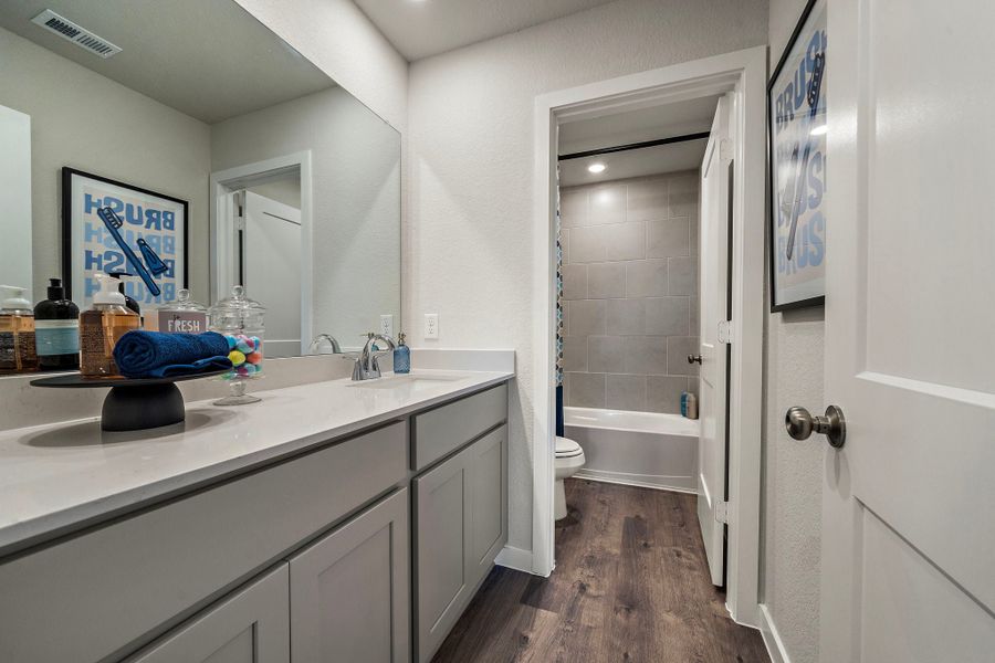 A bathroom with a tub sink and toilet.
