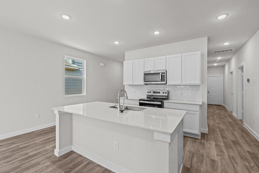 A kitchen with white cabinets. A kitchen with white cabinets.