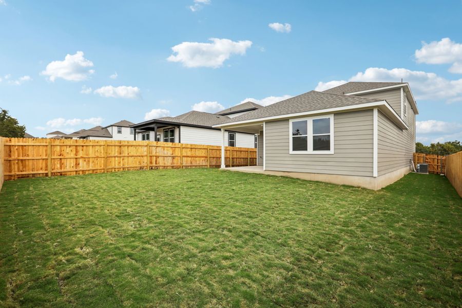 A house with a fence and grass.
