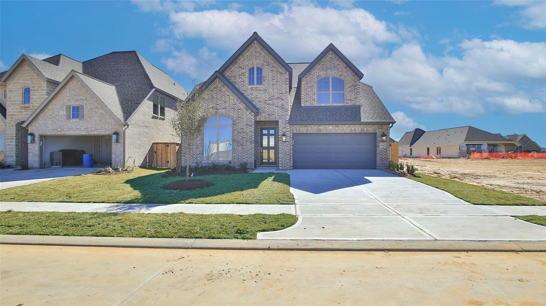 Front exterior of a new home in The Grand Prairie, Hockley, TX, highlighting curb appeal (Image 2).