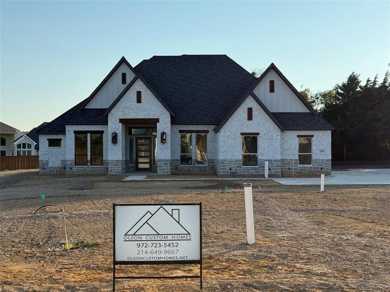 View of front of home with board and batten siding and roof with shingles View of front of home with board and batten siding and roof with shingles