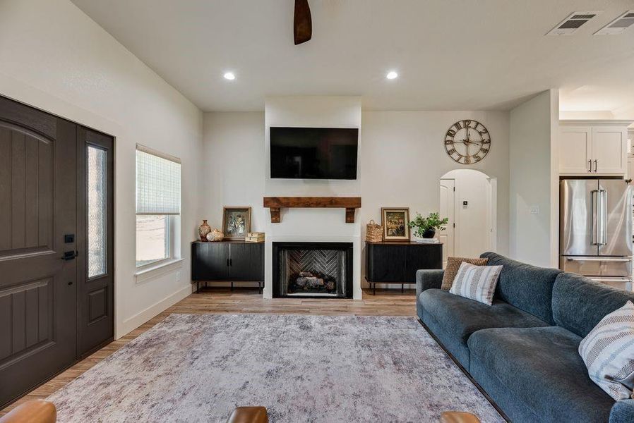 Amazing Living room with Stone fireplace, gas starter logs, and custom firebox that looks like a piece of artwork! 
Custom fabricated mantle and 10 foot ceilings