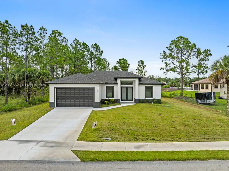 Front exterior of a new home in , Lehigh Acres, FL, highlighting curb appeal (Image 1). Front exterior of a new home in , Lehigh Acres, FL, highlighting curb appeal (Image 1).