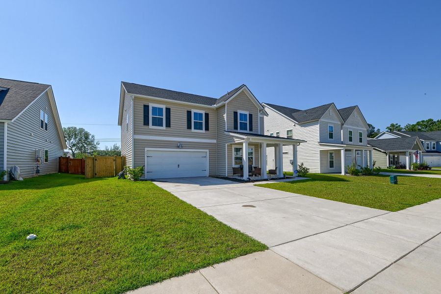 Front exterior of a new home in Heron's Walk at Summers Corner, Summerville, SC, highlighting curb appeal (Image 24).