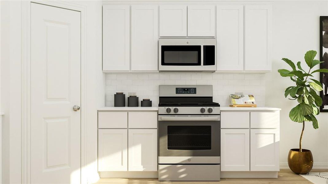 Kitchen with stainless steel appliances, light hardwood / wood-style floors, white cabinets, and tasteful backsplash