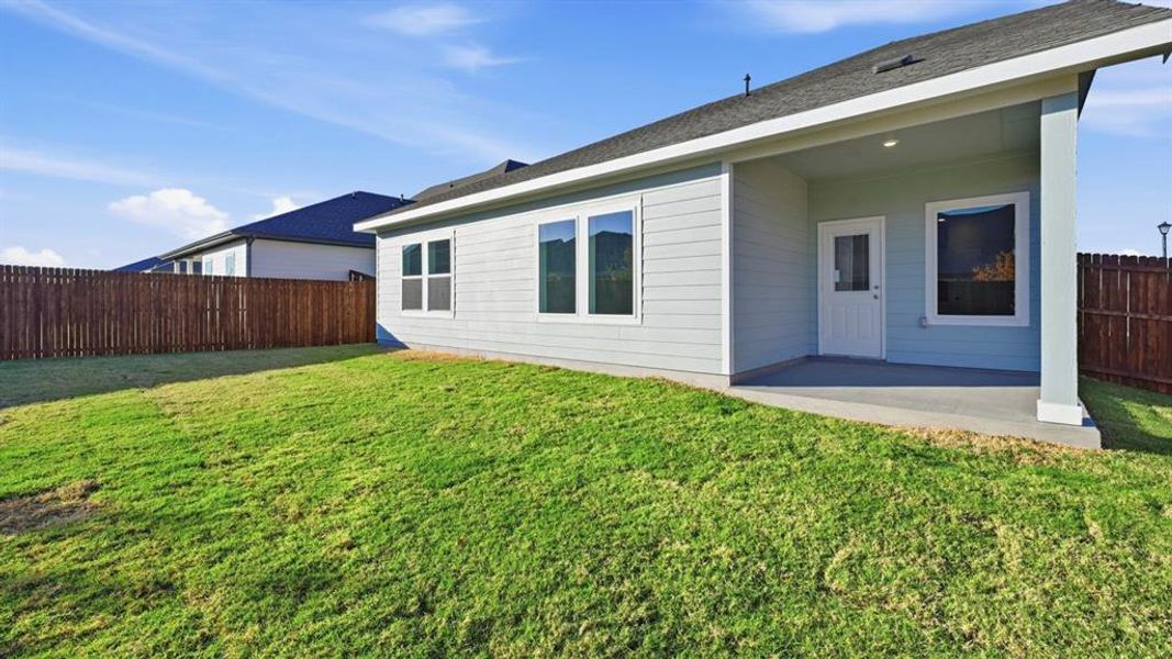 Back of property featuring a fenced backyard, a patio area, and roof with shingles Back of property featuring a fenced backyard, a patio area, and roof with shingles