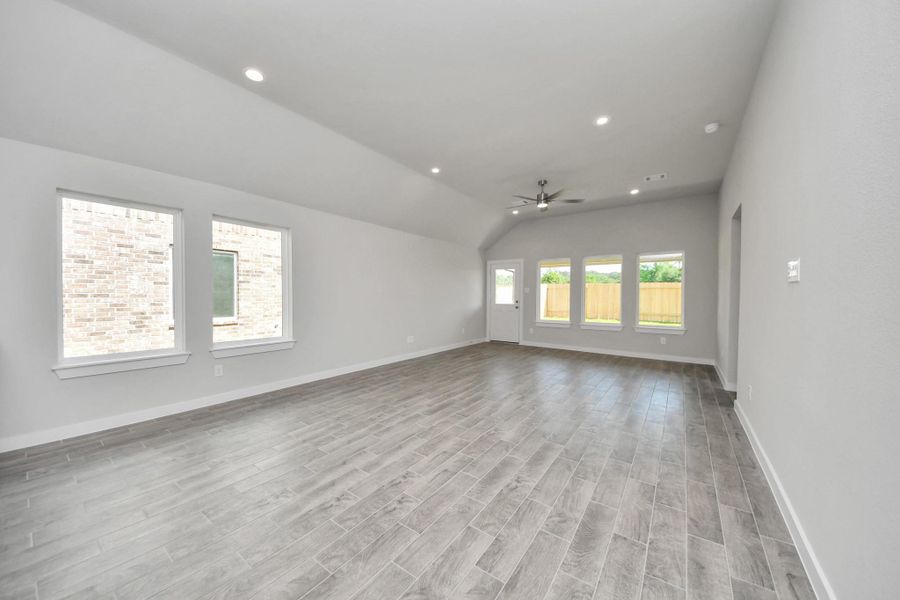 Gather the family and guests together in your lovely living room! Featuring soaring high ceilings, recessed lighting, ceiling fan, custom paint, gorgeous floors, and large windows that provide plenty of natural lighting throughout the day. Sample photo of completed home with similar floor plan. Actual colors and selections may vary. Gather the family and guests together in your lovely living room! Featuring soaring high ceilings, recessed lighting, ceiling fan, custom paint, gorgeous floors, and large windows that provide plenty of natural lighting throughout the day. Sample photo of completed home with similar floor plan. Actual colors and selections may vary.