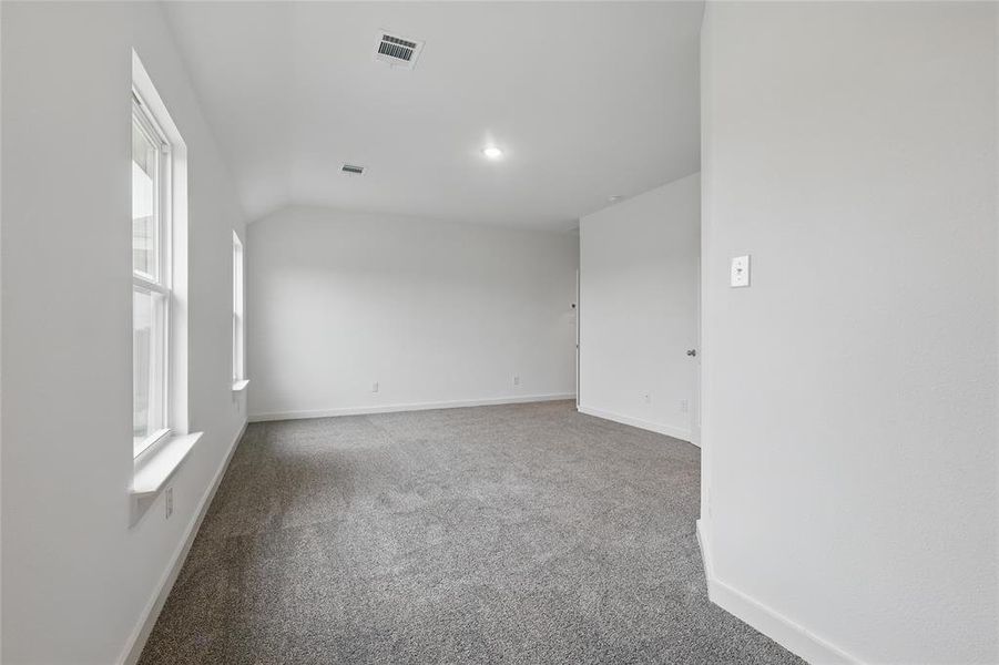 Unfurnished room with light carpet and baseboards Unfurnished room with light carpet and baseboards