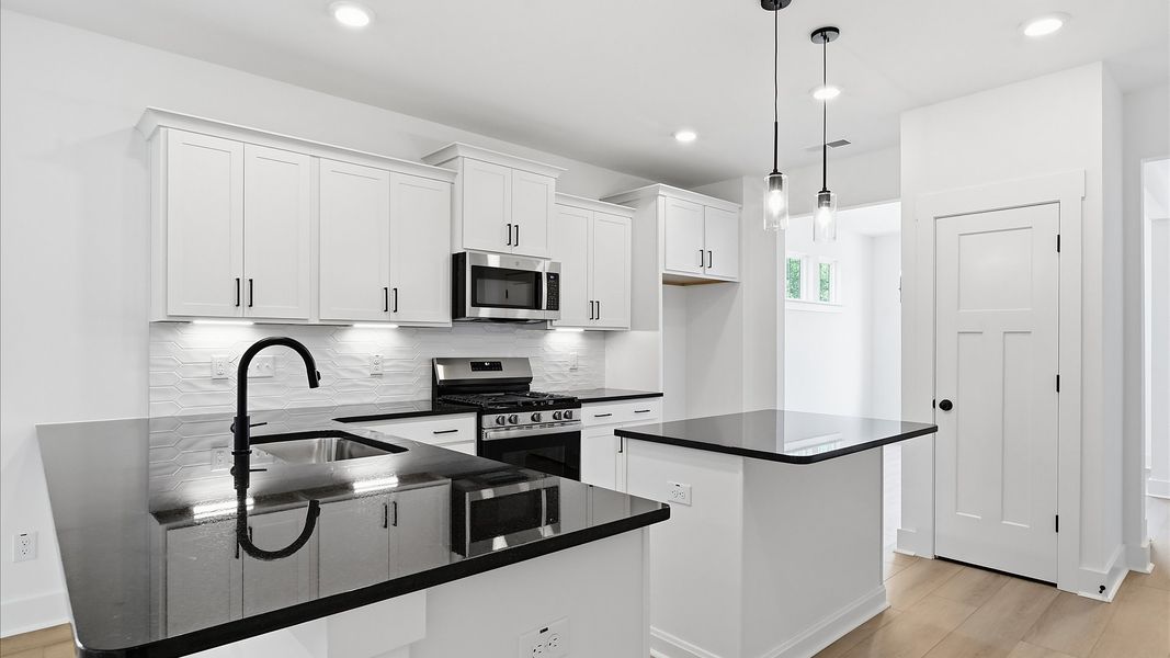Elegant kitchen featuring a functional island and clean, current styling throughout Elegant kitchen featuring a functional island and clean, current styling throughout