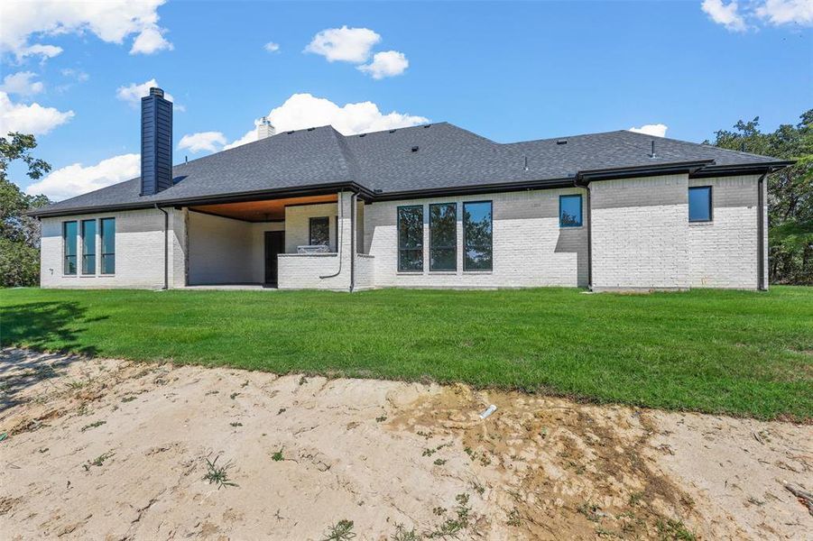 Rear view of house with a lawn