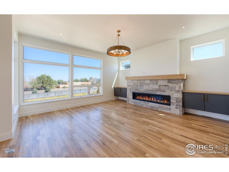 Living Room Features 10' Ceilings, 6' Mezzo Fireplace With Stone Surround, Large Windows With Views