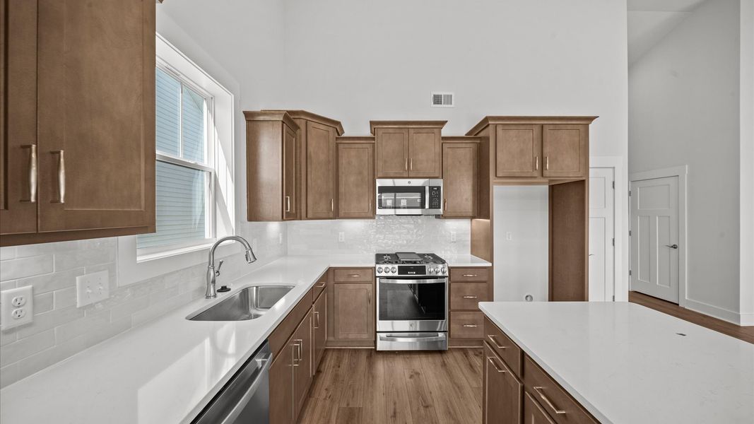 Elegant and compact island anchors this tasteful kitchen with high standards and timeless appeal