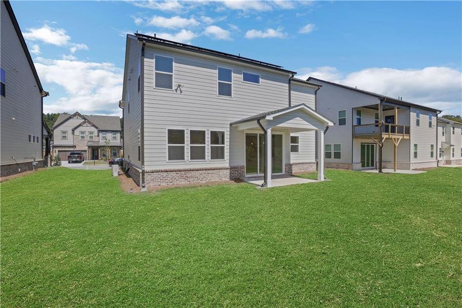 Exterior details and patio area of a home in The Paddocks at Doc Hughes, Buford (Image 3).