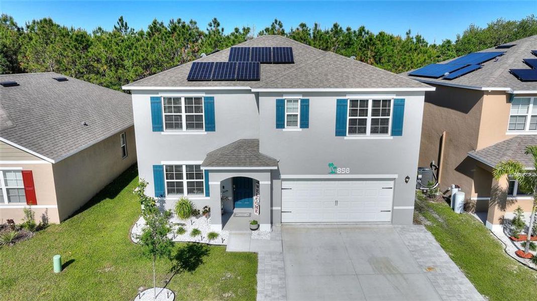 Front exterior of a new home in Squire's Grove, Winter Haven, FL, highlighting curb appeal (Image 2). Front exterior of a new home in Squire's Grove, Winter Haven, FL, highlighting curb appeal (Image 2).