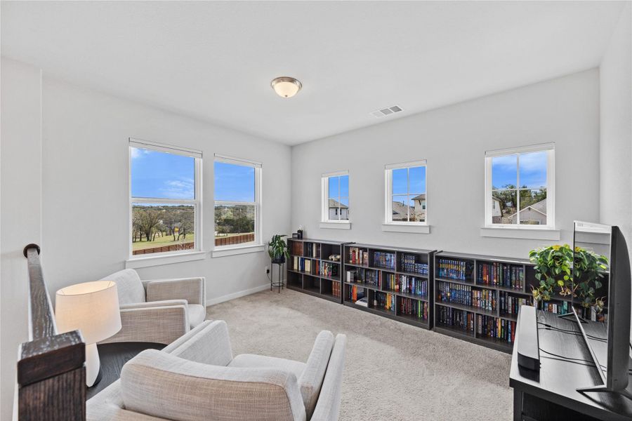 Sitting room with baseboards, visible vents, and carpet flooring