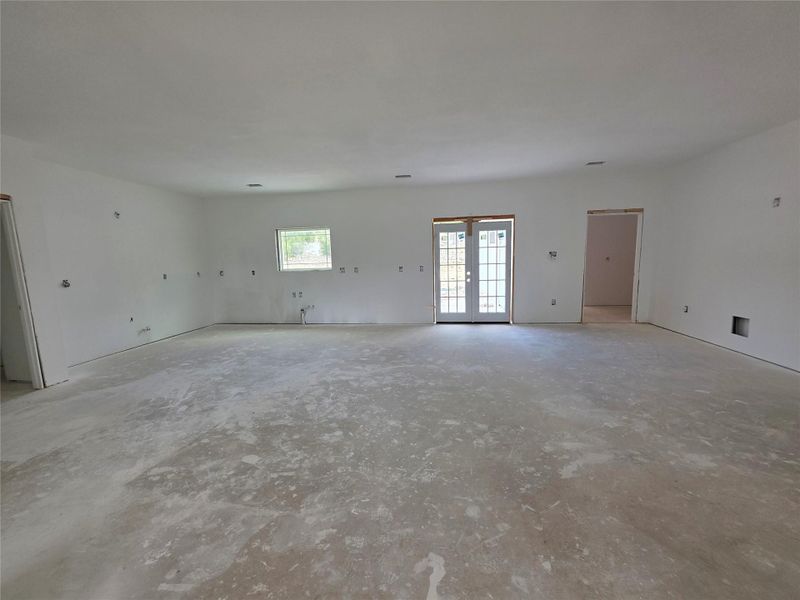 Spacious interior room with concrete flooring
