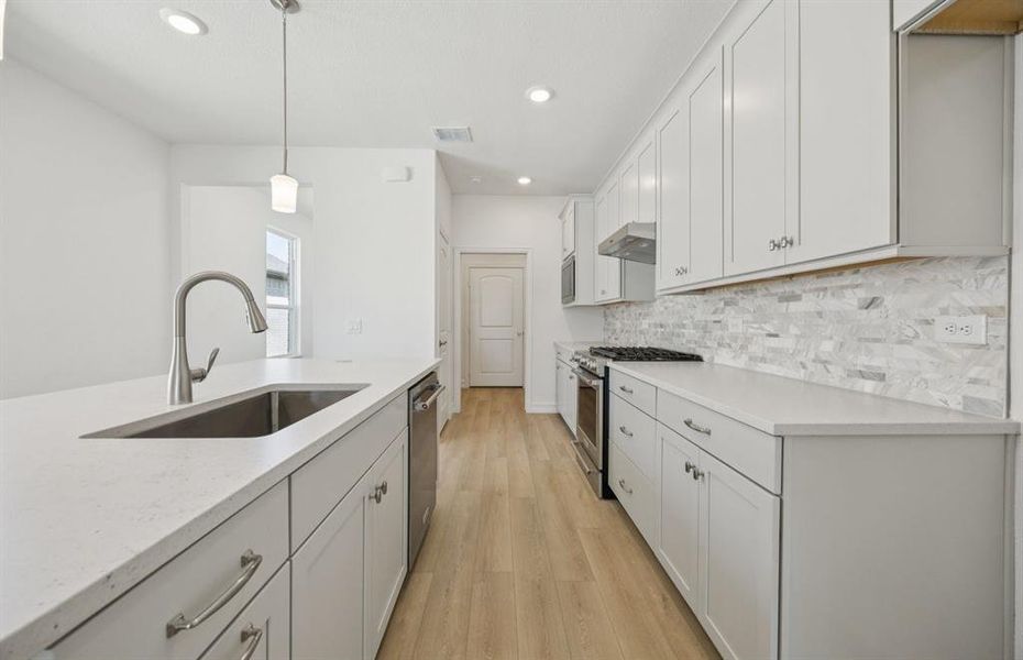 High-end gourmet kitchen with premium finishes and upgraded appliances *Real home pictured High-end gourmet kitchen with premium finishes and upgraded appliances *Real home pictured