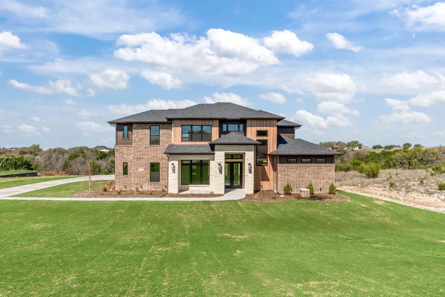 Front exterior of a new home in Eagles Bluff, Hudson Oaks, TX, highlighting curb appeal (Image 2). Front exterior of a new home in Eagles Bluff, Hudson Oaks, TX, highlighting curb appeal (Image 2).