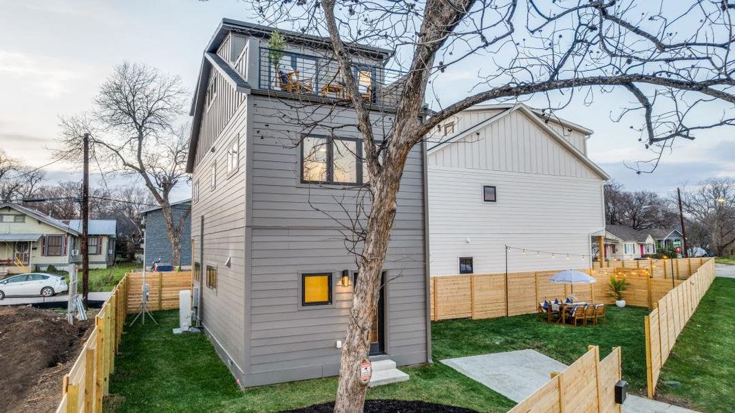 Rear view of property with a fenced backyard and board and batten siding