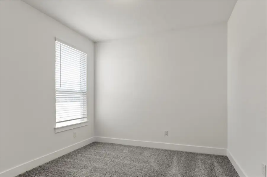 Empty room with carpet flooring and plenty of natural light