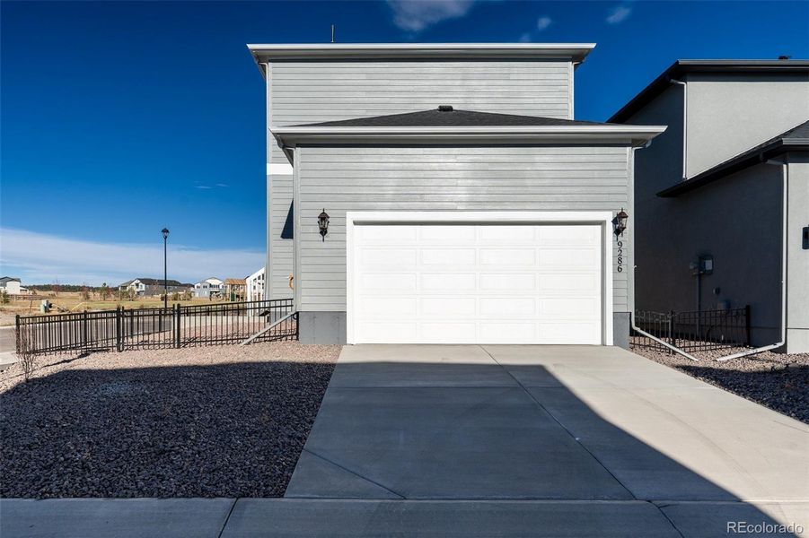 Front exterior of a new home in Revel Crossing at Wolf Ranch – The Outlook Collection, Colorado Springs, CO, highlighting curb appeal (Image 2).