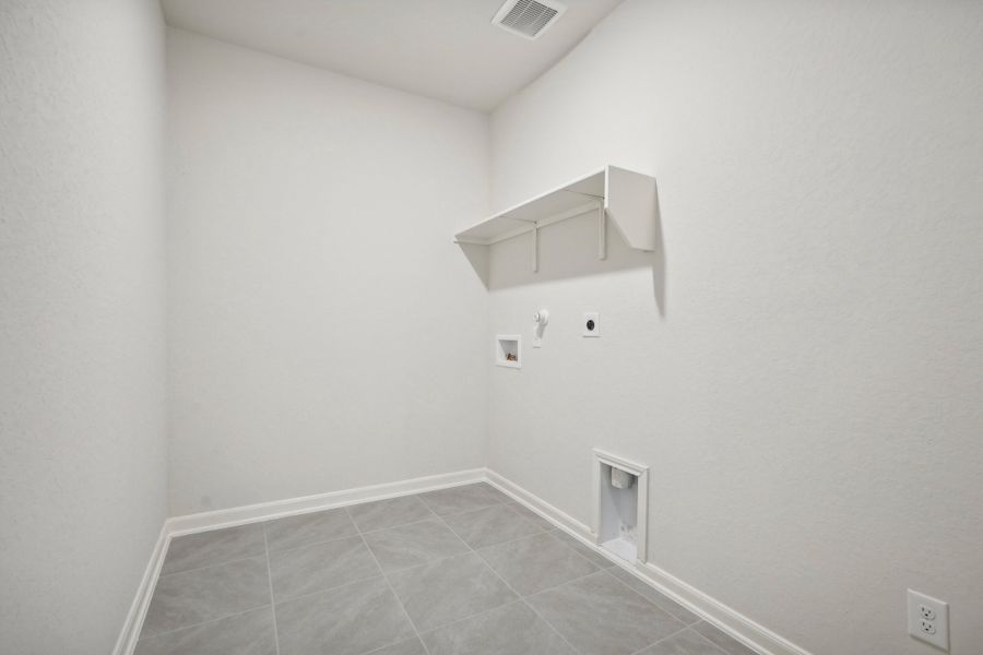 Laundry room in the Allen floorplan at a Meritage Homes community.