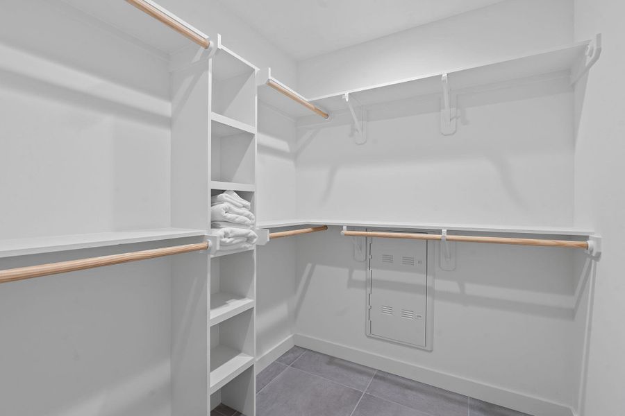 Spacious walk-in closet with custom built-in shelving