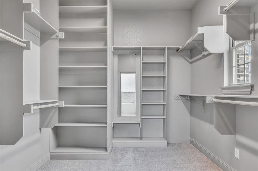 Walk in closet with light carpet