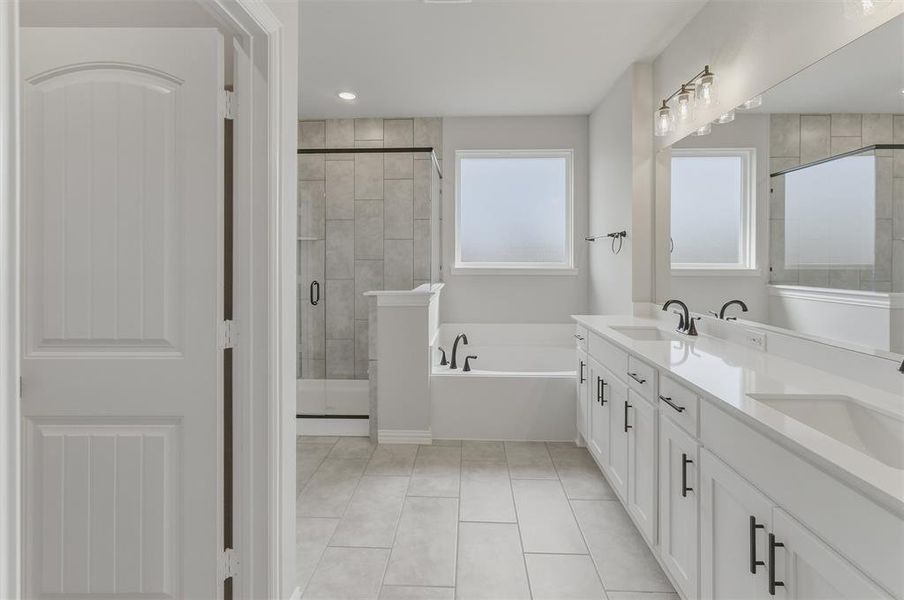 Modern bathroom with a dual vanity featuring white cabinetry, integrated sinks, and matte black hardware