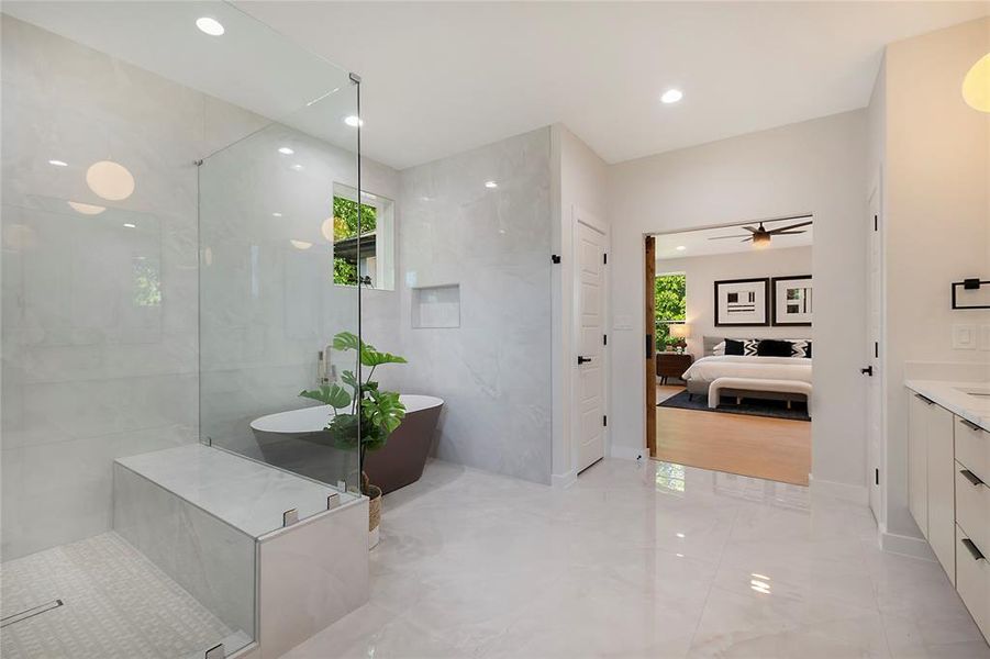 Primary Bathroom with vanity, ceiling fan, tile walls, independent shower and bath, and tile patterned flooring