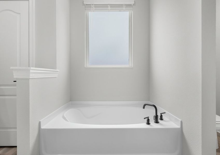 The master suite features a beautiful soaker tub.