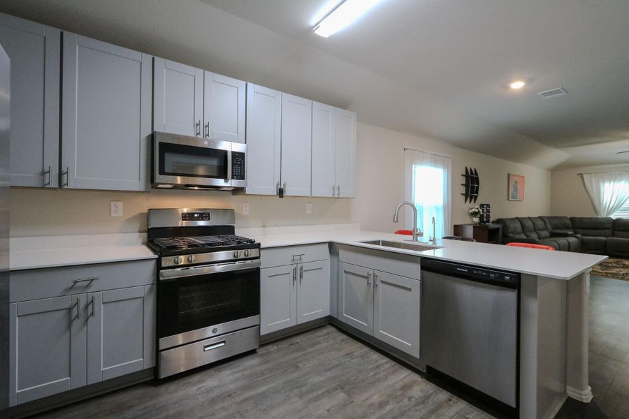 Upgraded kitchen opens to living & Dining with Quartz counter top, upgraded cabinets, new gas range& oven & microwave, and under mount sink & upgraded chrome hardwares. Upgraded kitchen opens to living & Dining with Quartz counter top, upgraded cabinets, new gas range& oven & microwave, and under mount sink & upgraded chrome hardwares.