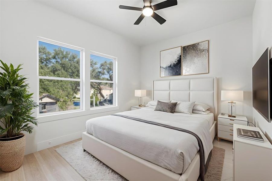 Bedroom featuring light wood-finish flooring and a contemporary ceiling fan