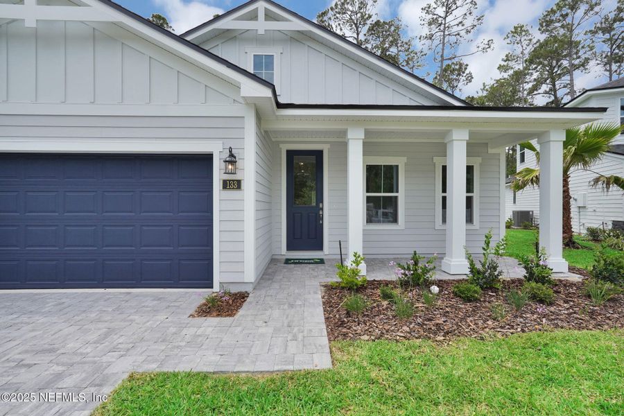 Front exterior of a new home in Landing at Olde Florida, St. Augustine, FL, highlighting curb appeal (Image 1).