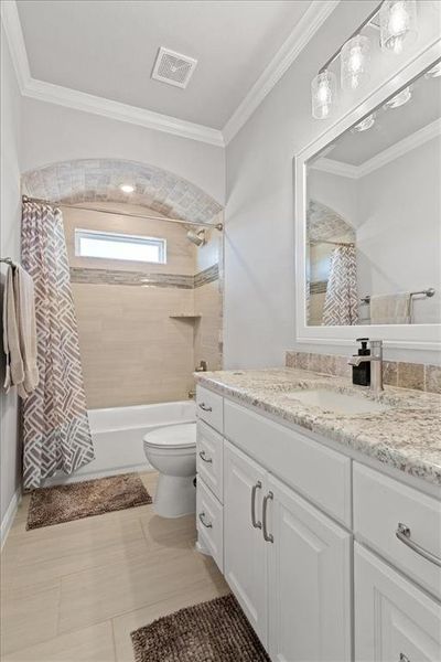 Full bath with shower / bath combo, visible vents, toilet, ornamental molding, and vanity