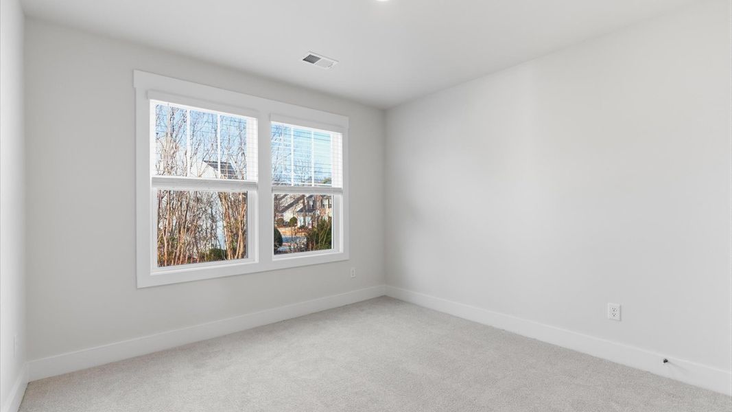 Refined bedroom design with large windows for daylight-filled mornings and peaceful views