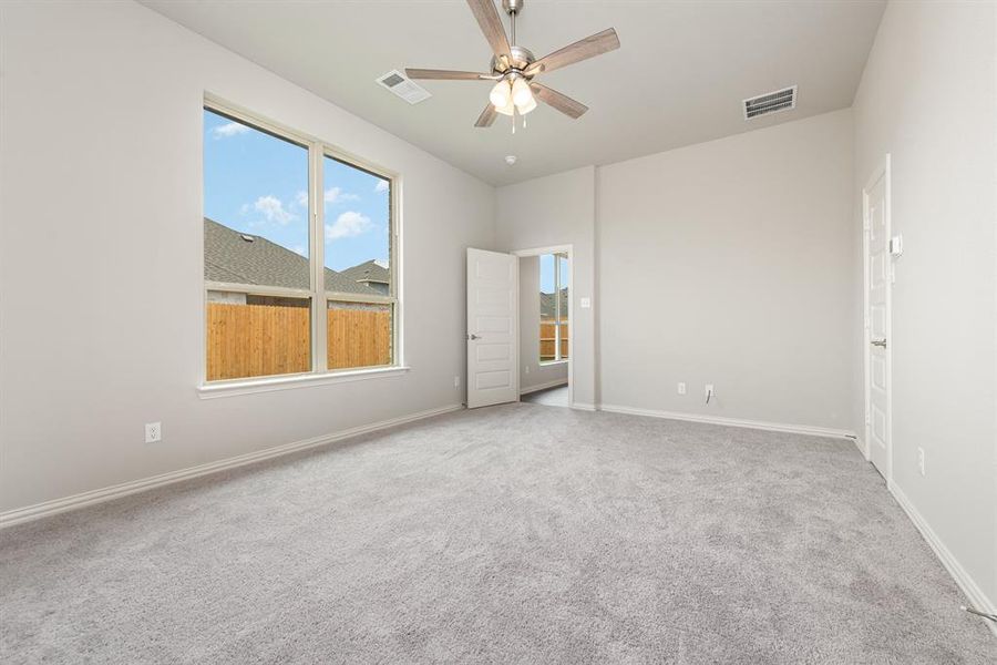 Empty room featuring carpet and ceiling fan