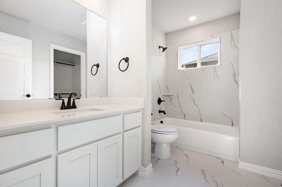 Bathroom featuring shower / washtub combination and vanity