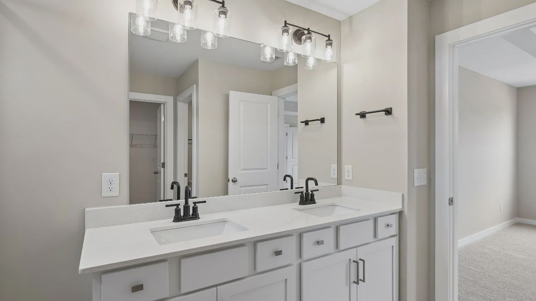 Bathroom with tile flooring and shower with glass enclosure, along with dual vanity Bathroom with tile flooring and shower with glass enclosure, along with dual vanity