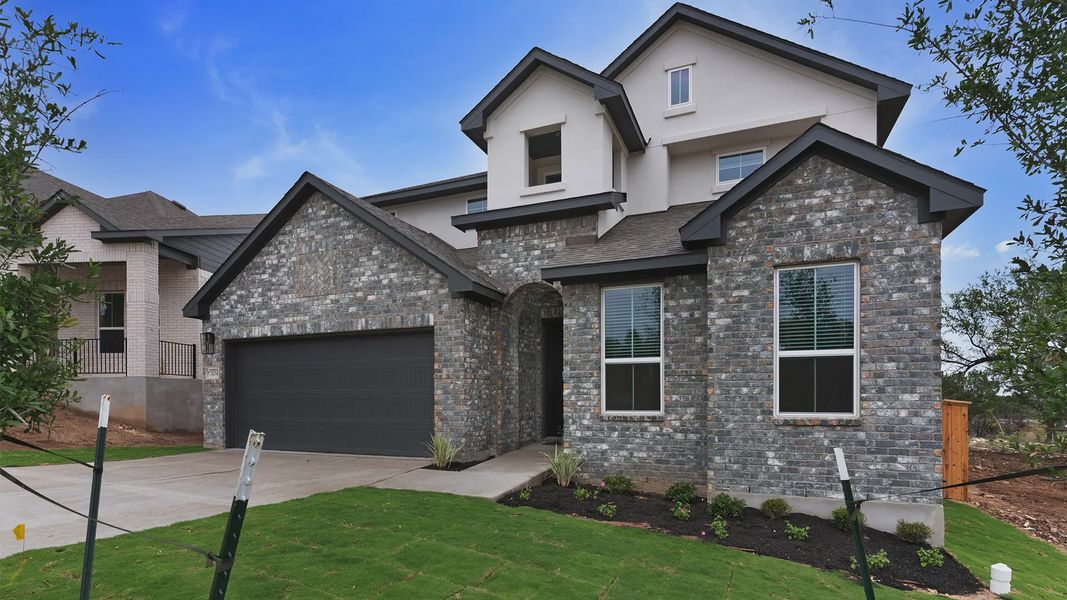 Representative exterior photo of a completed home built from the Maddy by Chesmar Homes in The Grove at Blackhawk, Pflugerville, TX (Image 2). Representative exterior photo of a completed home built from the Maddy by Chesmar Homes in The Grove at Blackhawk, Pflugerville, TX (Image 2).