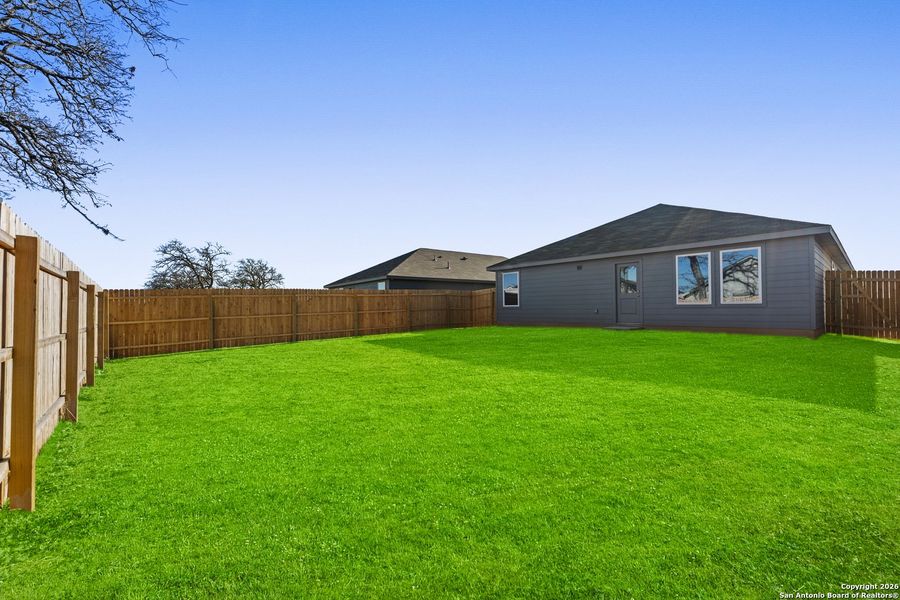 Exterior details and patio area of a home in Friendship Oaks, Fredericksburg (Image 2).