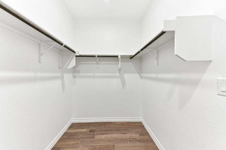Walk in closet featuring wood tiled floors Walk in closet featuring wood tiled floors